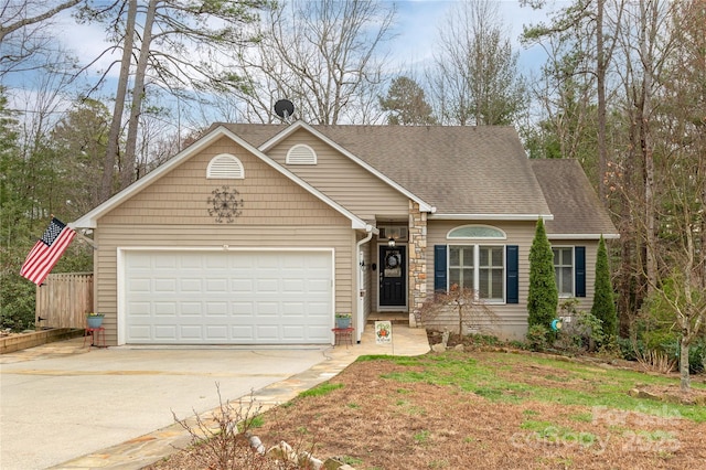 view of front of house featuring concrete driveway, a garage, and a shingled roof