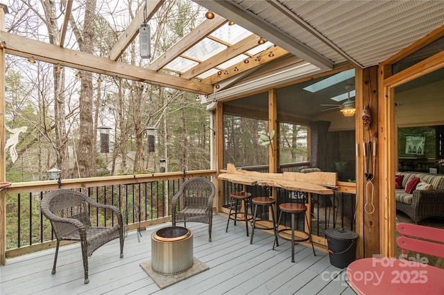 wooden deck featuring a sunroom