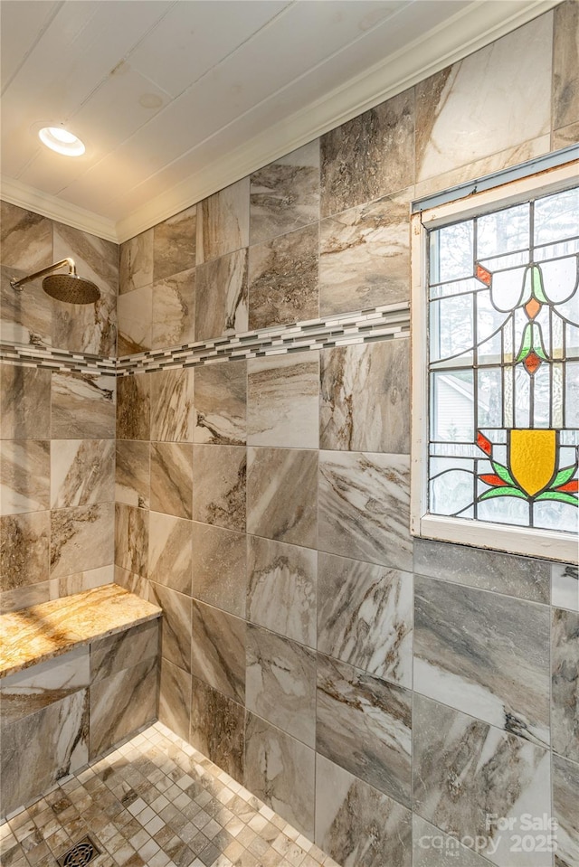 bathroom with tiled shower and ornamental molding