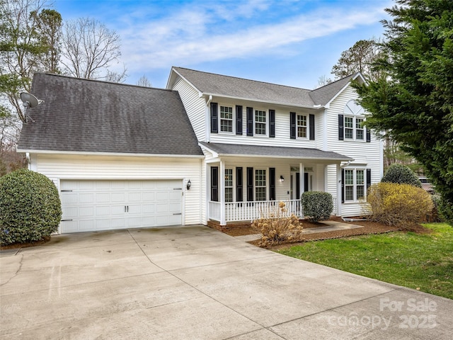 traditional home with a porch, an attached garage, driveway, and roof with shingles