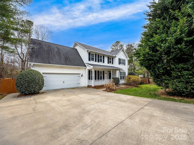 view of front of property with a porch, fence, concrete driveway, a front yard, and a garage