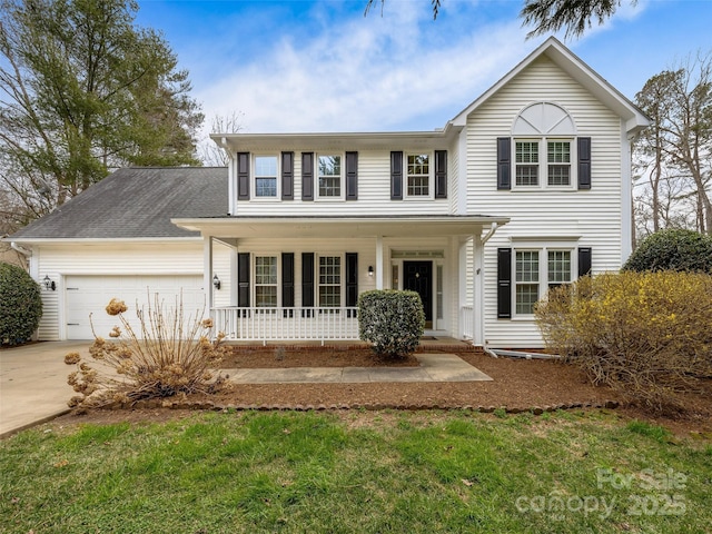 traditional-style home featuring a porch, concrete driveway, and an attached garage