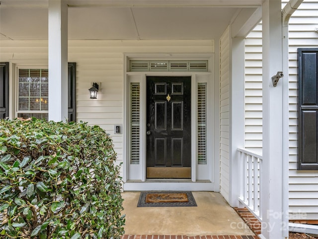 view of exterior entry featuring a porch