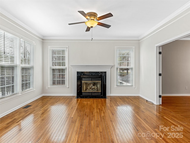 unfurnished living room with hardwood / wood-style floors, crown molding, visible vents, and ceiling fan