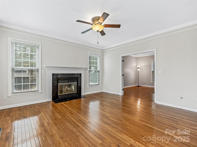 unfurnished living room with ornamental molding, wood-type flooring, and ceiling fan