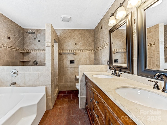 bathroom featuring tiled shower, toilet, tile walls, and a sink