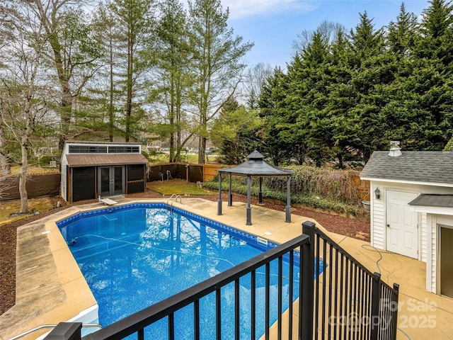 view of pool with a fenced backyard, an exterior structure, a gazebo, an outdoor structure, and a fenced in pool