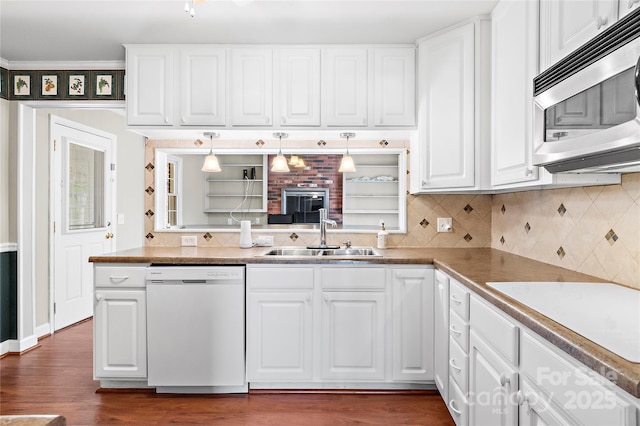 kitchen with tasteful backsplash, white cabinets, white appliances, and a sink