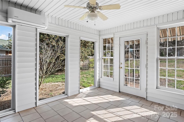 unfurnished sunroom featuring ceiling fan and a wall unit AC