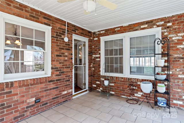 unfurnished sunroom with a healthy amount of sunlight and a ceiling fan