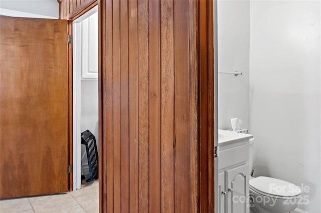 bathroom featuring tile patterned flooring, toilet, and vanity