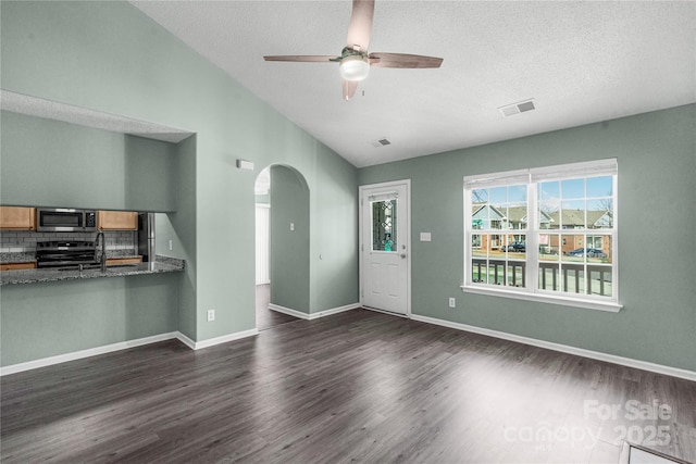 8421 Kings Creek Dr, Charlotte, NC 28273 - unfurnished living room featuring a ceiling fan, visible vents, arched walkways, dark wood-style flooring, and vaulted ceiling