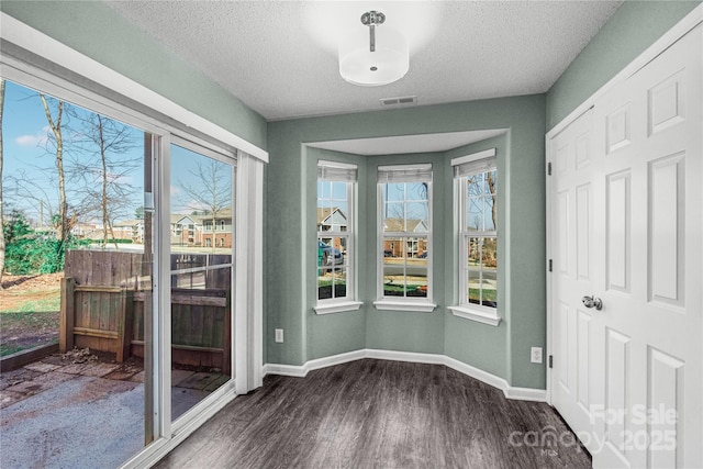 8421 Kings Creek Dr, Charlotte, NC 28273 - interior space with visible vents, a textured ceiling, dark wood-type flooring, and baseboards