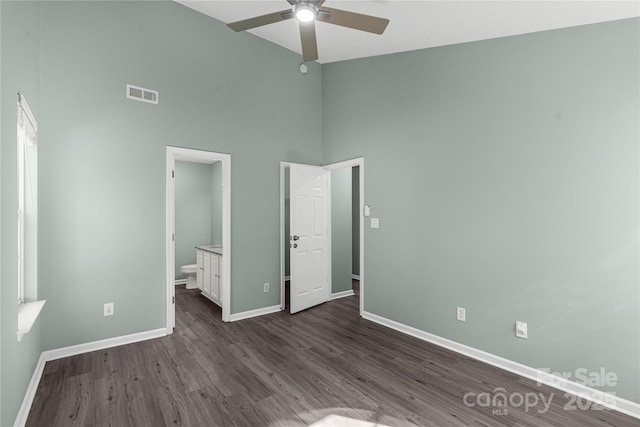 8421 Kings Creek Dr, Charlotte, NC 28273 - unfurnished bedroom featuring baseboards, visible vents, high vaulted ceiling, dark wood-type flooring, and connected bathroom