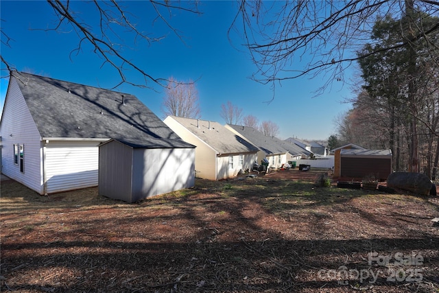 8421 Kings Creek Dr, Charlotte, NC 28273 - exterior space featuring a storage unit, an outdoor structure, and roof with shingles