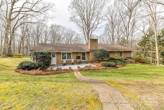 single story home featuring a chimney, a front yard, and a patio