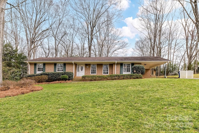 single story home with an attached carport, brick siding, and a front yard