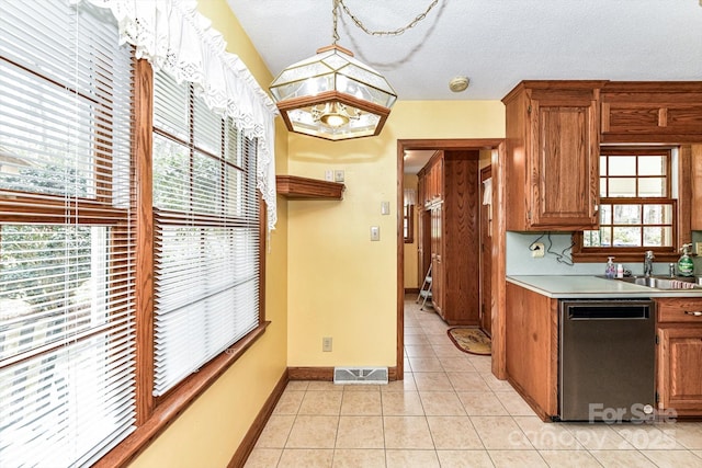 kitchen featuring light tile patterned floors, visible vents, a sink, light countertops, and dishwasher