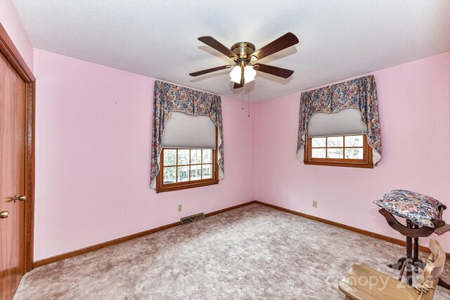 unfurnished bedroom with visible vents, baseboards, carpet floors, a closet, and a textured ceiling