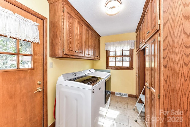 laundry area with a wealth of natural light, visible vents, cabinet space, and independent washer and dryer