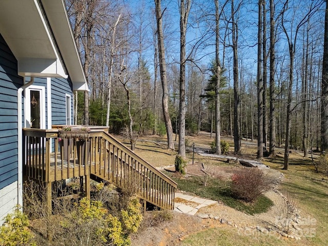 view of yard with a deck and stairway