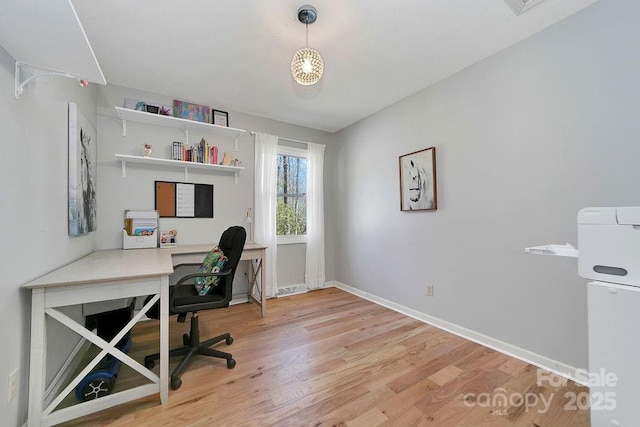 home office featuring baseboards and wood finished floors