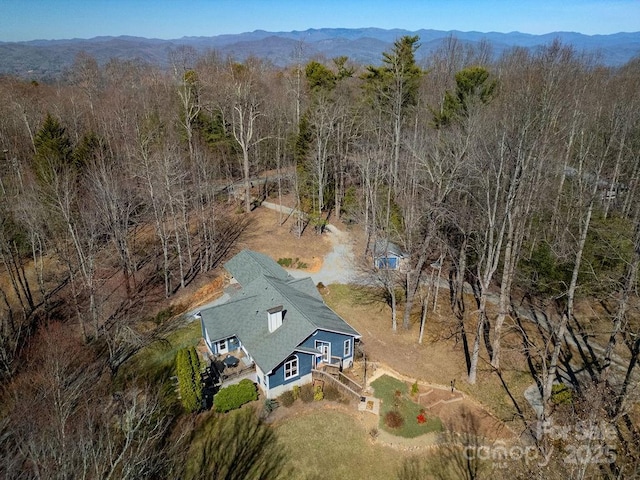 bird's eye view with a forest view and a mountain view