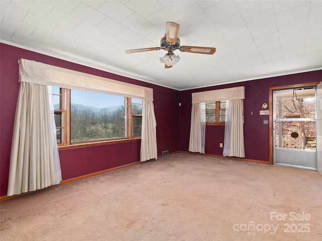 unfurnished living room with visible vents, ceiling fan, and carpet flooring