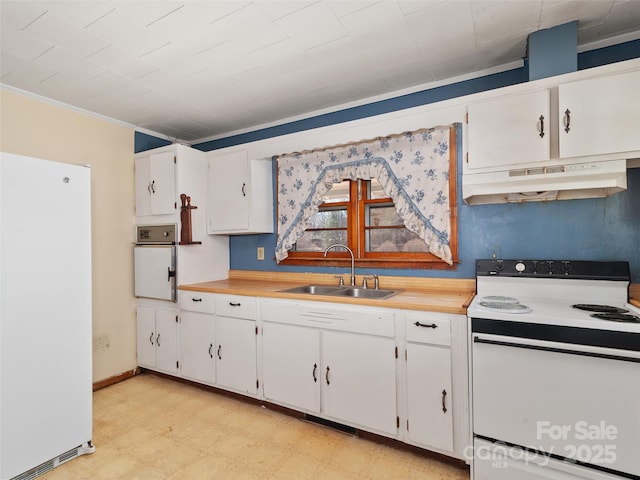 kitchen featuring white appliances, light floors, a sink, under cabinet range hood, and white cabinetry