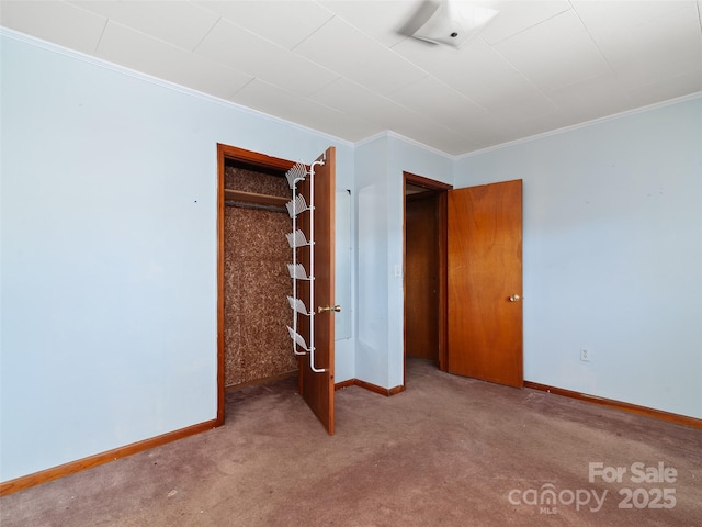 unfurnished bedroom with baseboards, carpet, and crown molding