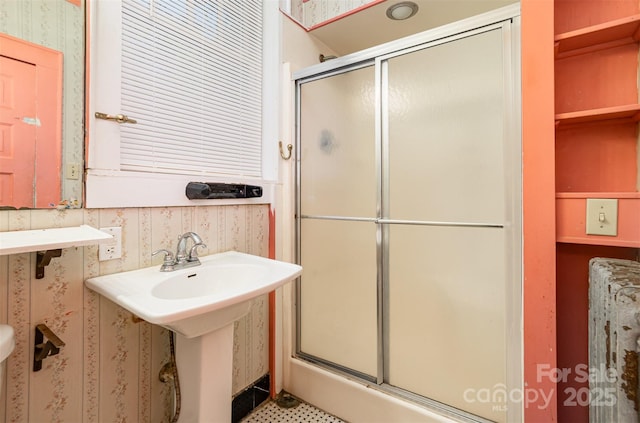 full bath with a shower stall and wallpapered walls