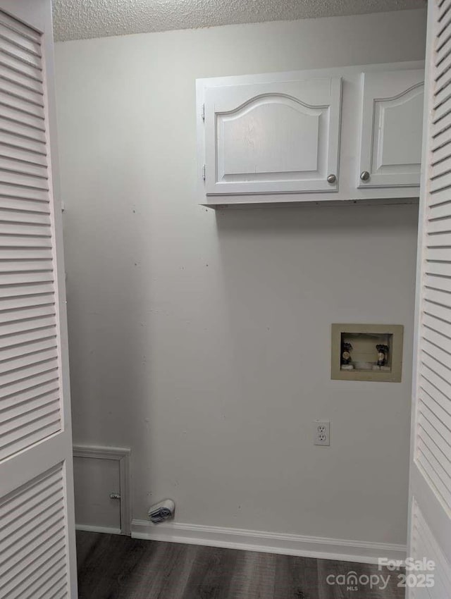 laundry area featuring washer hookup, dark wood-style floors, cabinet space, and baseboards