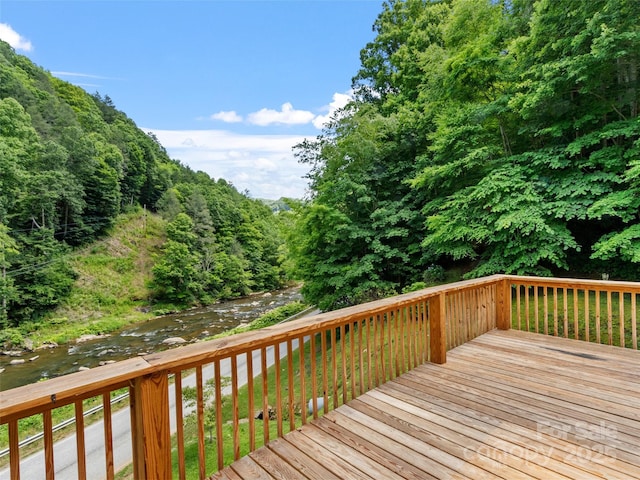 wooden deck featuring a forest view