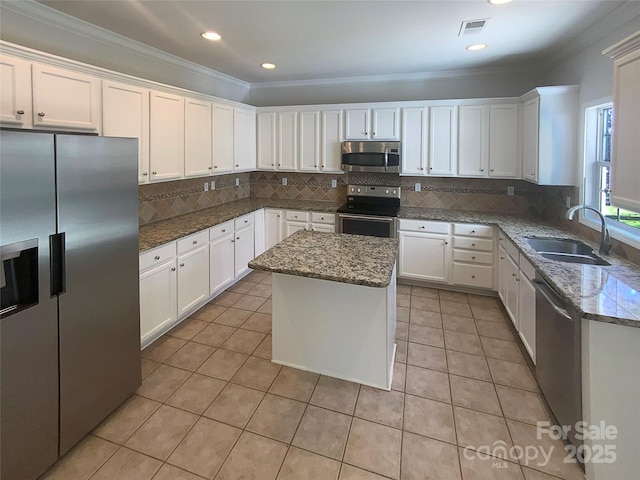 kitchen featuring white cabinetry, light tile patterned flooring, appliances with stainless steel finishes, and a sink