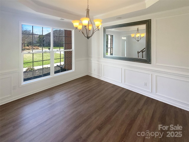 unfurnished dining area with a decorative wall, a notable chandelier, and dark wood-style flooring