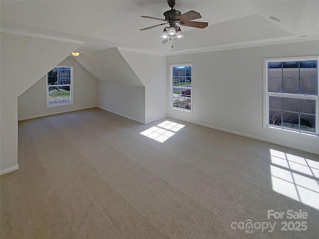 additional living space with baseboards, carpet, a ceiling fan, and vaulted ceiling