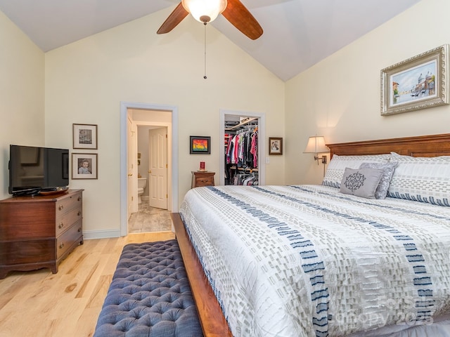 bedroom with a walk in closet, light wood-type flooring, ensuite bath, ceiling fan, and a closet