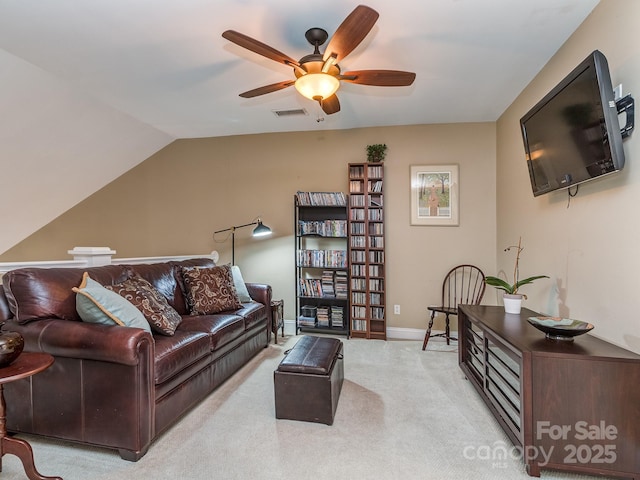 carpeted living room with a ceiling fan, baseboards, lofted ceiling, and visible vents