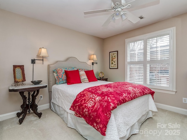 carpeted bedroom with baseboards, ceiling fan, and visible vents