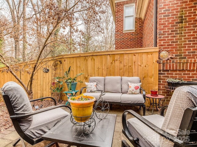 view of patio featuring outdoor lounge area and a fenced backyard
