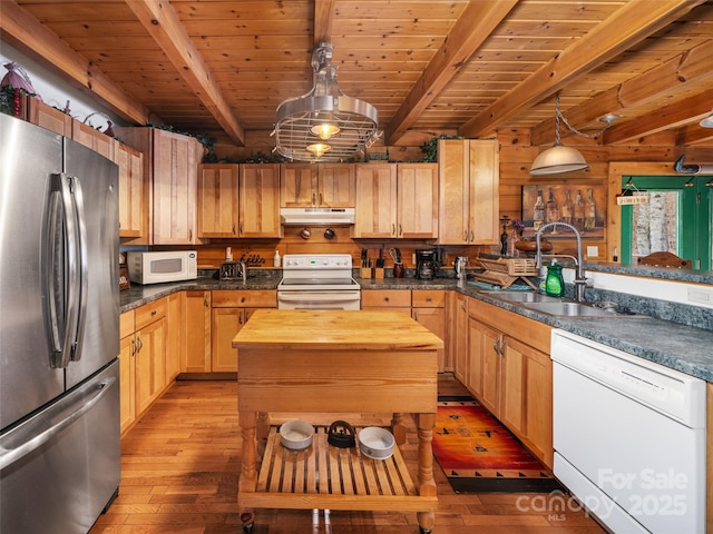 kitchen featuring light wood-type flooring, butcher block countertops, a sink, under cabinet range hood, and white appliances