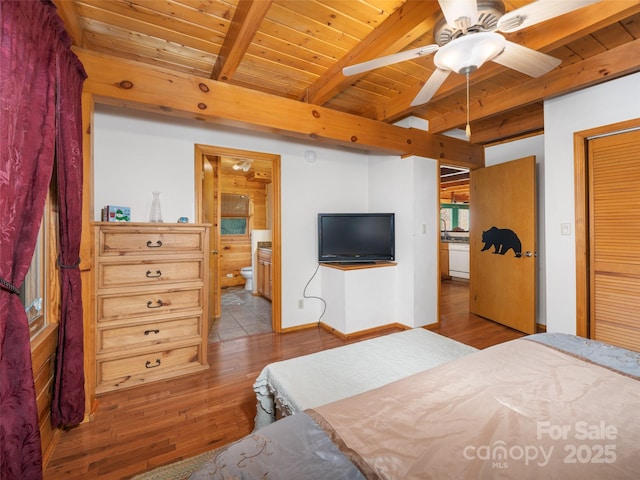 bedroom featuring ensuite bath, wood finished floors, wood ceiling, and beam ceiling