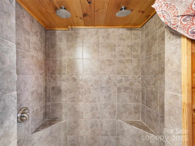 details with wood ceiling and a tile shower