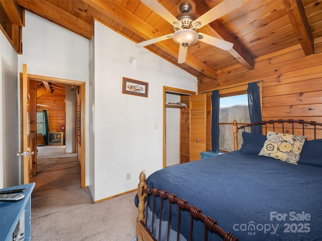 bedroom featuring wooden walls, carpet floors, vaulted ceiling with beams, wood ceiling, and a closet