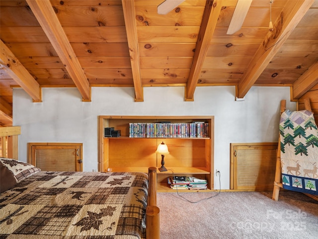 unfurnished bedroom featuring beamed ceiling, wooden ceiling, and carpet floors