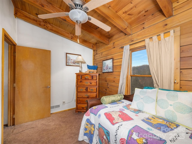 carpeted bedroom with vaulted ceiling with beams, wooden walls, wood ceiling, and visible vents