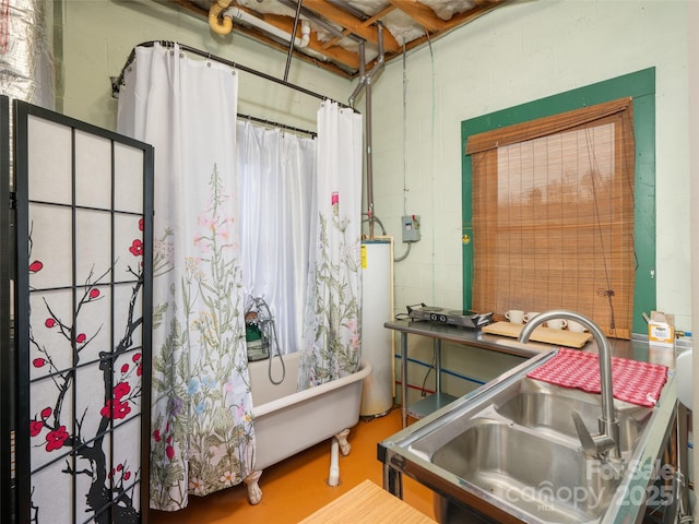 full bath with a sink, gas water heater, concrete floors, concrete block wall, and a bathtub