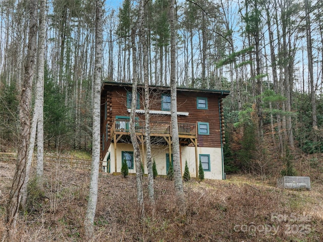 view of front of house with a wooden deck and log exterior