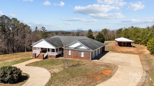 single story home featuring a front yard, driveway, roof with shingles, a porch, and a garage