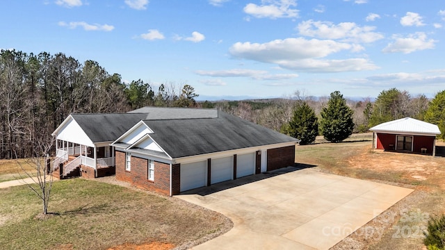 single story home featuring a front yard, an attached garage, brick siding, and driveway